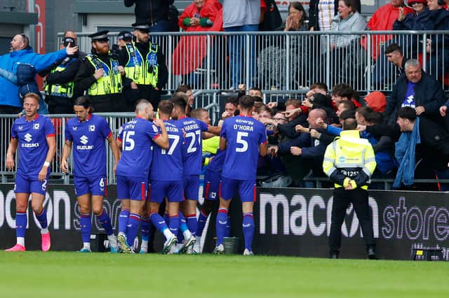 MK Dons celebrate with travelling supporters in their win over Wrexham