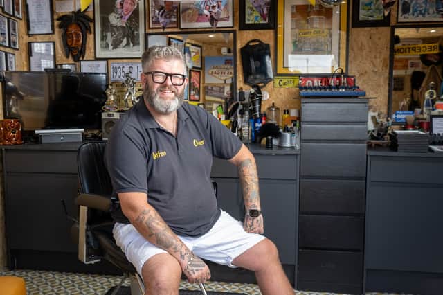 Nathan Scotford in his back garden barber shop.