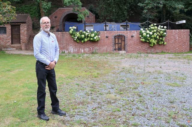 Stephen Cuddy with the mini canal lock he built to house a narrowboat turned into a swimming pool.