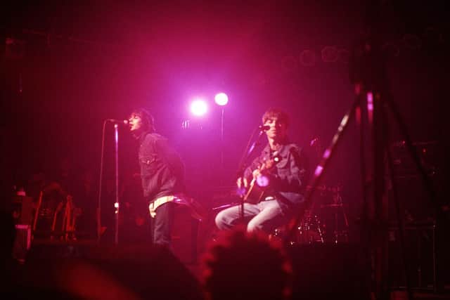 Liam Gallagher and Noel Gallagher of Oasis perform on stage at The Electric Ballroom, Camden on May 9 1996 (Photo by Getty Images) 