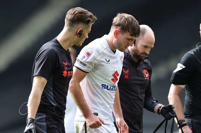 Laurence Maguire needed treatment before coming off against Walsall on Saturday