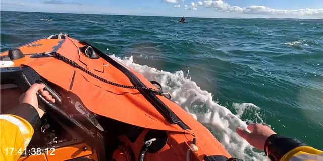 Windsurfer is rescued by RNLI after boom snapped.