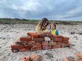Heidi and Thea on the beach on Holy Island. Meet the family who live on an island that can only be accessed twice a day and only has five children in the local school. 