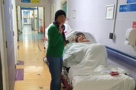 Maria Bodea, 86, and daughter Sanda as they wait in hospital corridor after Maria was admitted to hospital after a suspected heart attack.
