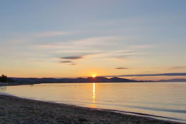The sunrise over the Sithonia peninsula from the Blue Lagoon Queen hotel's beach.