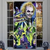 Beetlejuice themed Halloween decorations like this door cover are all the rage this year