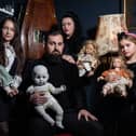 JP Kennedy and Kymmi Jeffery with daughters Snow and Pebble (L-R), known as The Occult Family, holding haunted dolls inside their haunted room.
