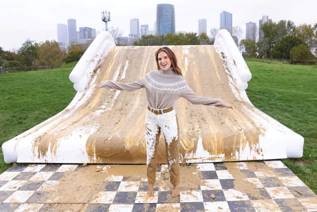 Binky Felstead encourages families to embrace the mud this half term as she's spotted going down a 2.5m high mudslide, created by Bosch at Mudchute Farm.