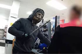 Moment armed robber in Halloween mask raids shop till.
