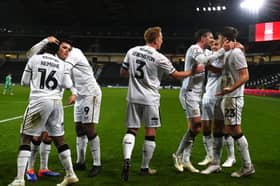 MK Dons celebrate Laurence Maguire's late winner against Cheltenham