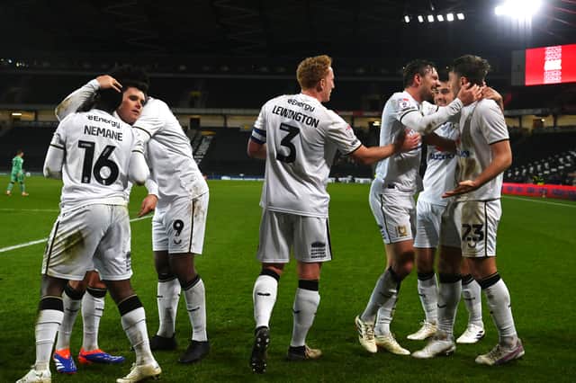 MK Dons celebrate Laurence Maguire's late winner against Cheltenham