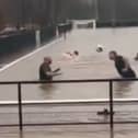 Lydney Town AFC players go swimming on their pitch.