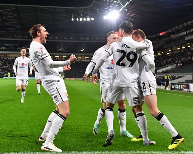 MK Dons celebrate Scott Hogan's goal after 12 seconds