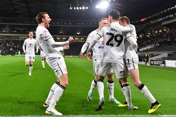 MK Dons celebrate Scott Hogan's goal after 12 seconds