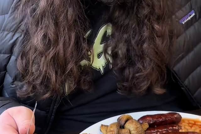 Kalani Smith reviewing a full English breakfast. British cafe goes viral after US TikToker gives glowing reviews of a full English breakfast.