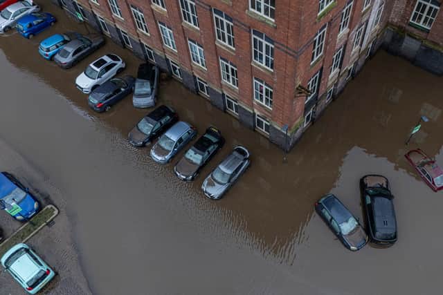 Car are flooded outside a newly converted Meadow Mill on Water street in Stockport as emergency teams arrive to rescue people trapped inside. January 1 2025.