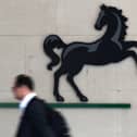 A man passes the entrance to a Lloyds Banking Group office in the City of London (Photo: JUSTIN TALLIS/AFP via Getty Images)