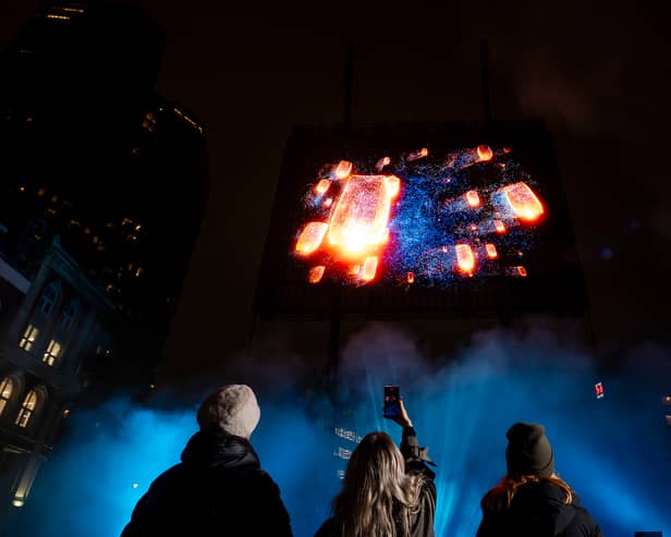 Visuals of a blue whale, northern lights, and football tricks are displayed in a hologram show over London