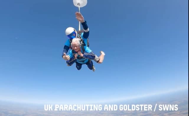 A 102-year-old lady skydiving with an instructor