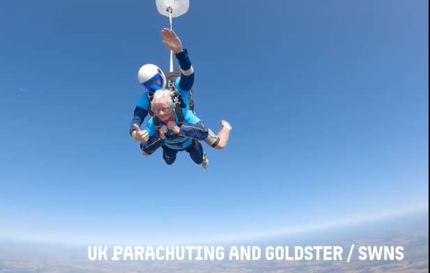 A 102-year-old lady skydiving with an instructor
