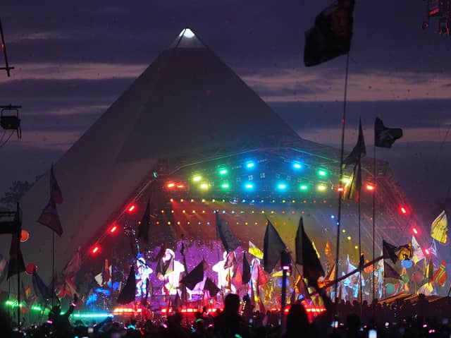 The crowd watching Coldplay performing on the Pyramid Stage at the Glastonbury Festival