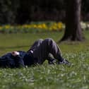 A man sleeps on the grass.