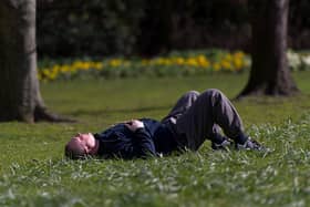 A man sleeps on the grass.