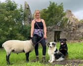 Robyn Swan moved out of her home to live rent-free in a container in rural Scotland, growing her own food and harvesting rainwater. She is pictured with her pet sheep and dogs. Photo: Robyn Swan / SWNS