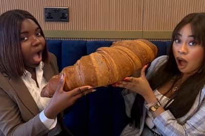Emmanuella Okpoko with a friend and the massive croissant at P&D Gran Caffè in Liverpool on March 28 2025.