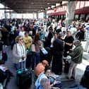 People wait outside the Atocha train station in Madrid after its closure as a massive power outage hits Spain.