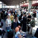 People wait outside the Atocha train station in Madrid after its closure as a massive power outage hits Spain.