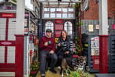 Train-mad couple Richard Cantrell and Katherine Siggins with dog Jess in the back garden at their home-made 'station'.
