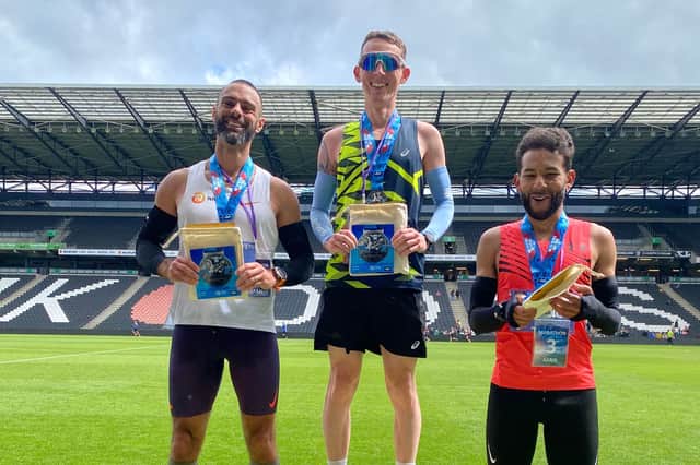 The male podium celebrating at Stadium MK