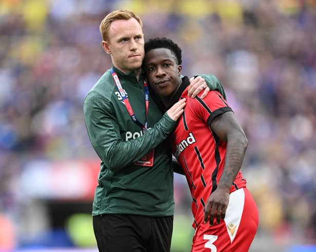 Walsall's Liam Gordon is consoled by Danny Johnson after their play-off final defeat