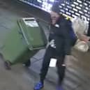 Reece Wheat drags the wheelie bin of stolen goods.