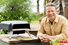 Jamie Oliver with his Tefal gas pizza oven, designed for quick, even-cooked homemade pizzas in the garden