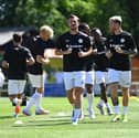 MK Dons warming up against Hitchin Town