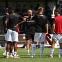 Paul Warne speaks with his players during warm-up