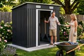 The charcoal black metal shed is designed to bring practical storage and a more modern look to outdoor spaces