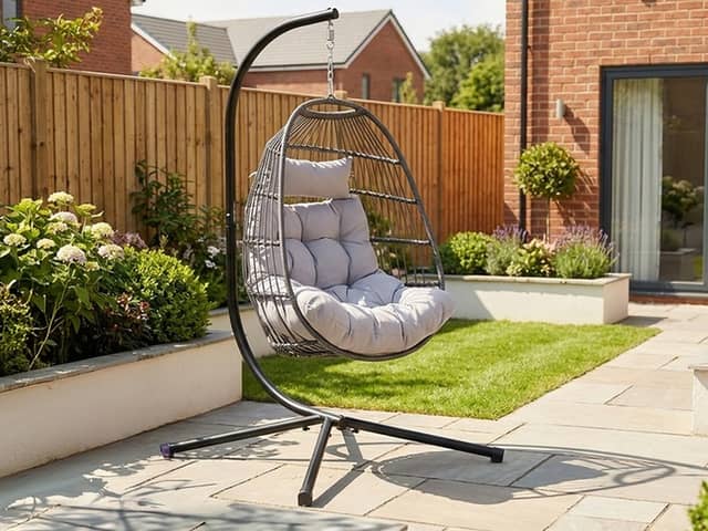 The dark grey hanging egg chair stands 202cm tall and comes with removable washable cushions