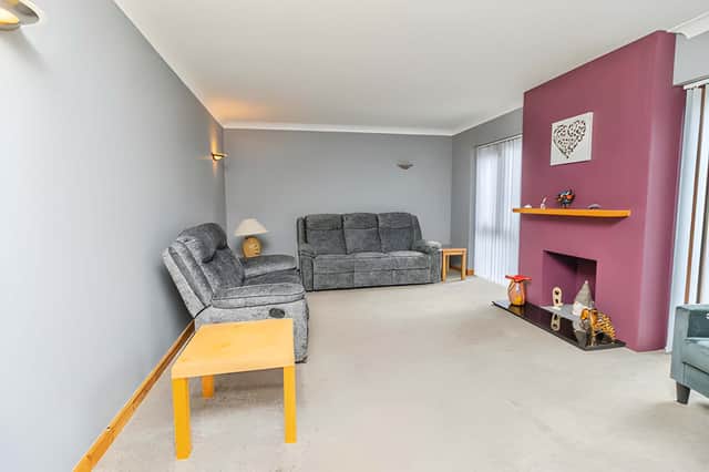 The living room is one of several reception spaces on the ground floor, alongside the dining room and study