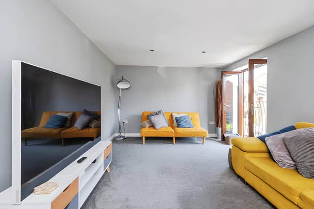 The spacious sitting room offers a dedicated reception space on the first floor of this versatile home