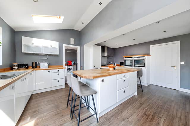 An extended open kitchen and dining space provides a substantial hub for everyday family life