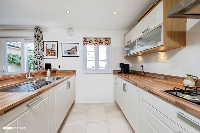 The stylish open-plan kitchen and dining room creates a flexible hub for everyday family life and entertaining