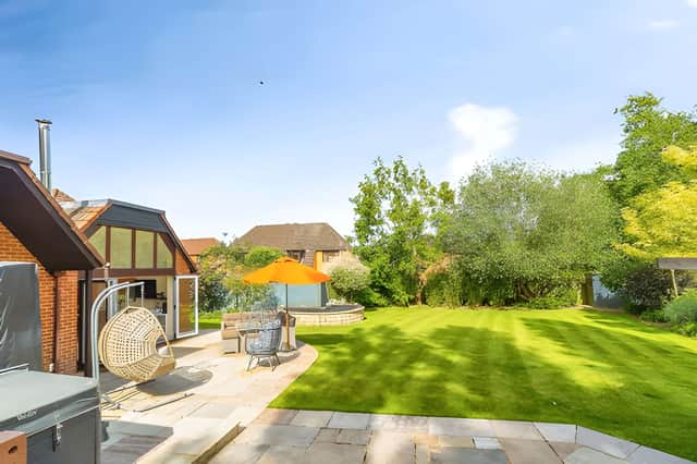Wrap-around private gardens give the property a substantial outdoor setting around its large plot