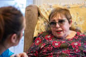 Lorna, who lives with PSP, talking to her carer. 