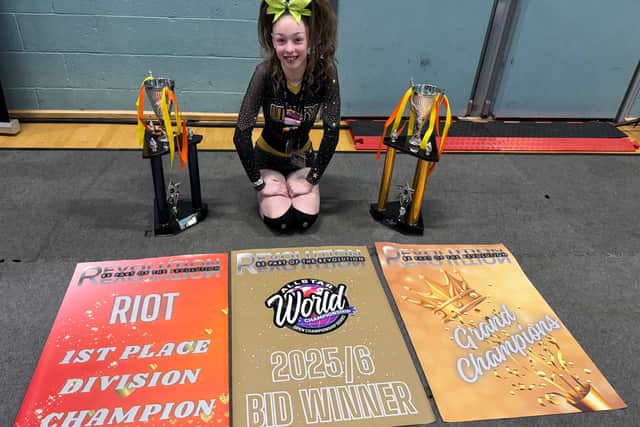 Harriet celebrates with trophies and the Allstar Worlds bid award after her team Strike's success at Revolution Riot in Worcester in March 2026.