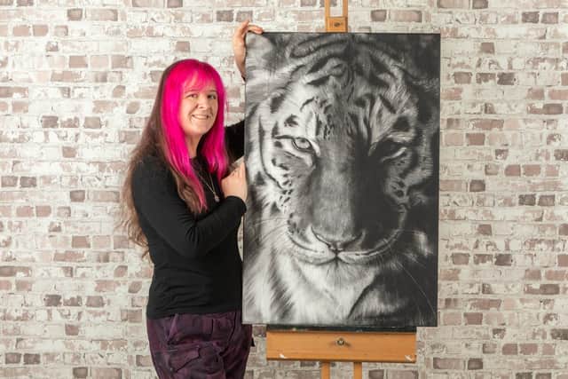 Becky with her drawing "Tyger, Tyger" drawn in charcoal on Canvas.