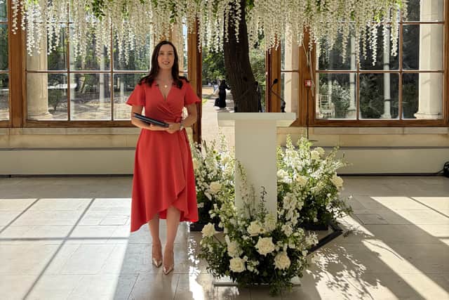 Buckinghamshire celebrant holding folder during Kew Gardens wedding ceremony