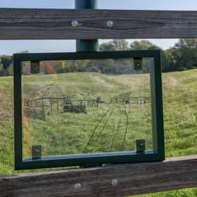 Viewing panel shows the outline of a medieval village, helping visitors see the hidden history